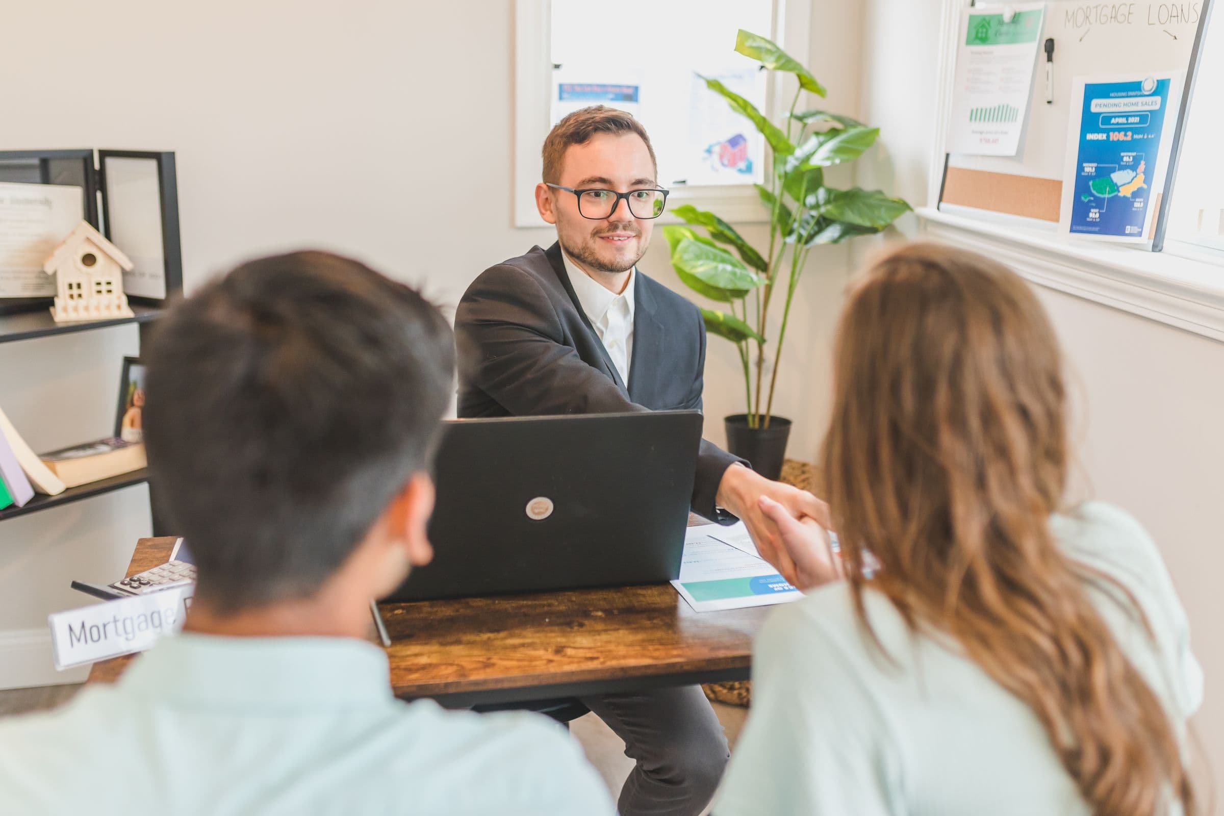 A licensed Texas loan officer reviewing a loan with clients