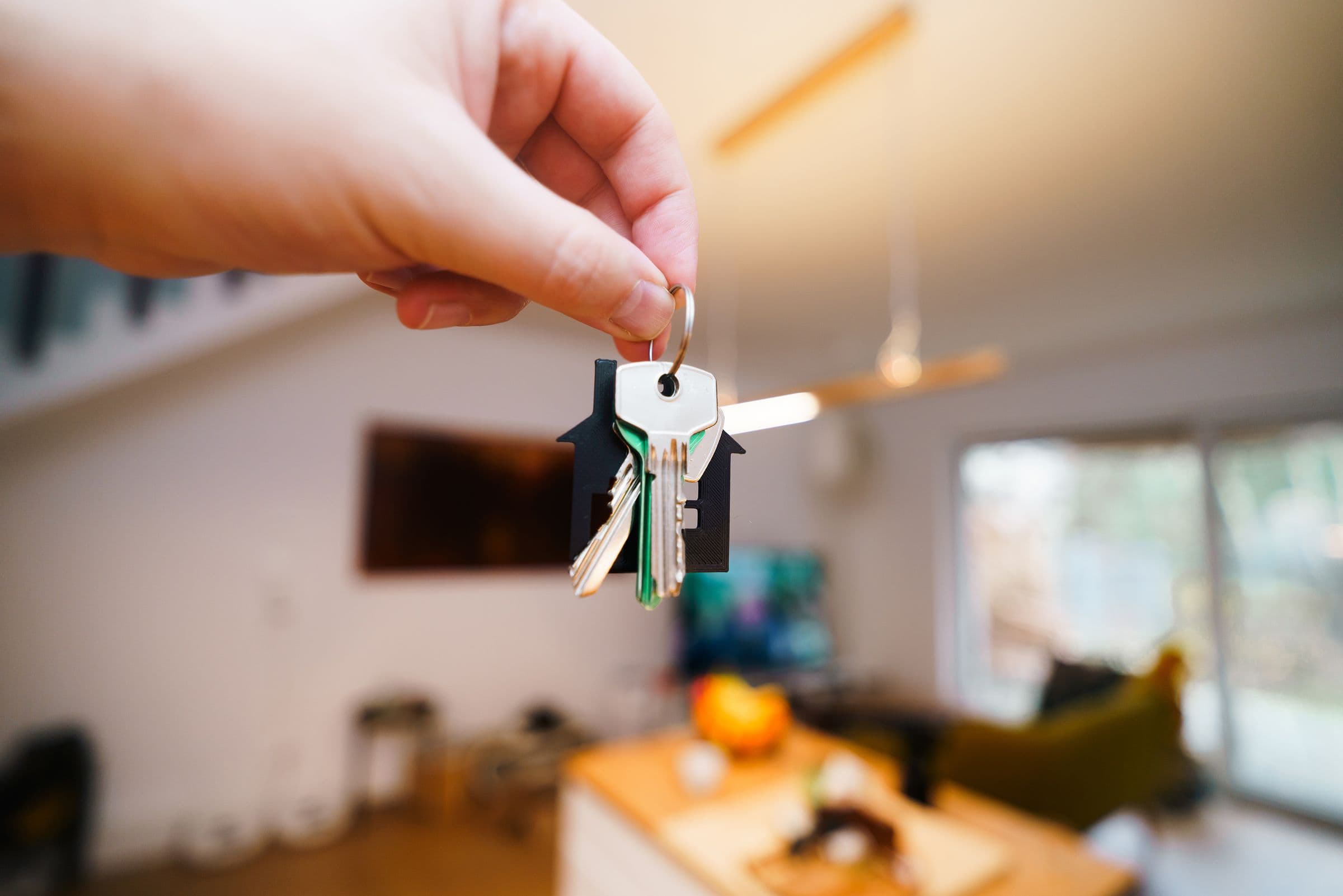 A hand holding the keys to a new home